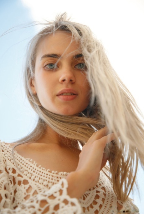 Platinum blonde teen Sofy Bee removes a lace dress to go naked on rocky ground 51767425